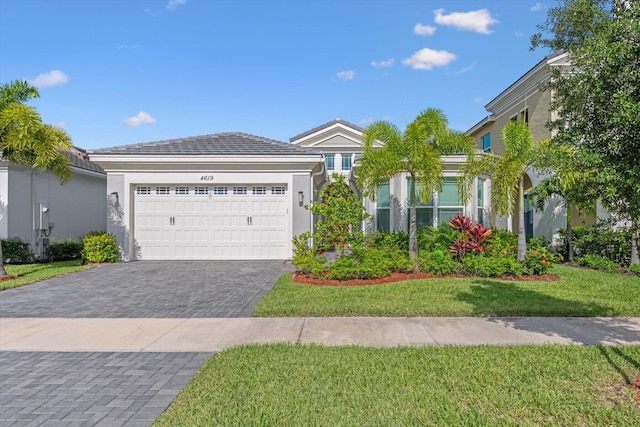 view of front of home with a garage and a front lawn