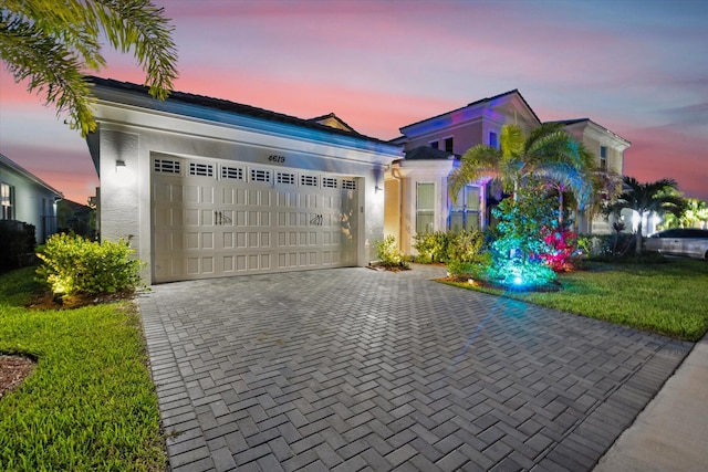 view of front facade featuring a lawn and a garage