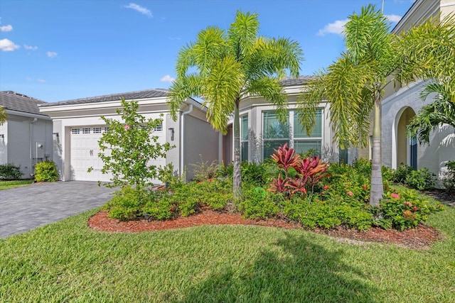 view of front of house with a garage and a front lawn