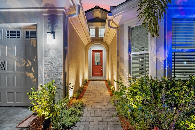 exterior entry at dusk with a garage