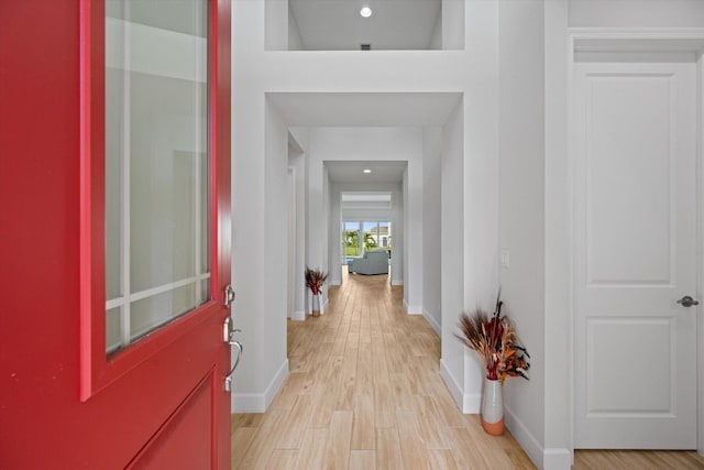 hallway with light hardwood / wood-style flooring