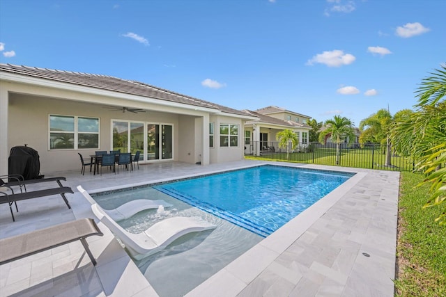 view of pool with grilling area, ceiling fan, a lawn, and a patio