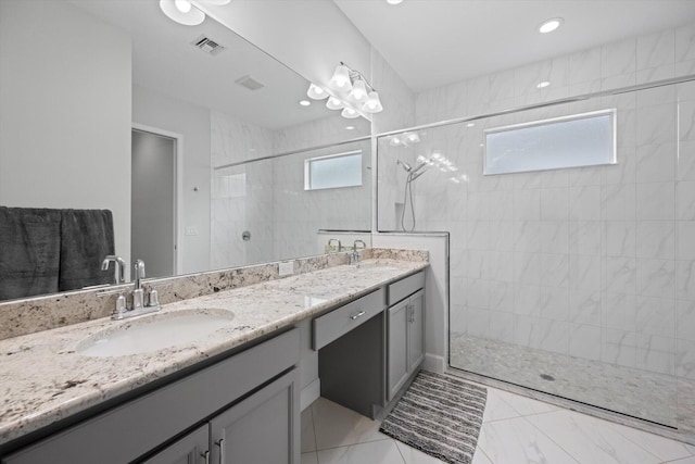 bathroom featuring vanity and tiled shower