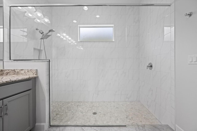 bathroom featuring vanity and tiled shower