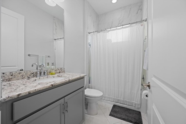 bathroom featuring toilet, vanity, and tile patterned flooring