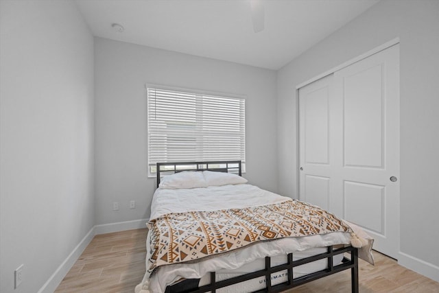 bedroom featuring ceiling fan, a closet, and light hardwood / wood-style floors