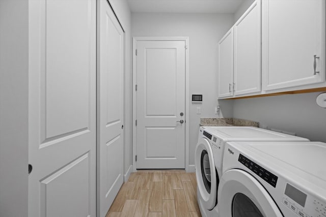 washroom featuring cabinets and separate washer and dryer