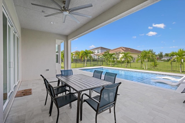 view of pool with ceiling fan and a patio