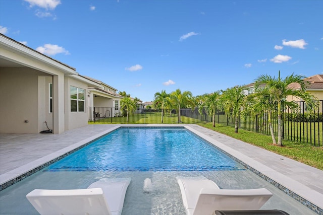 view of pool with a yard and a patio