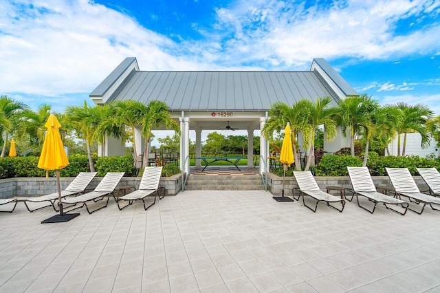 view of patio with ceiling fan and a gazebo