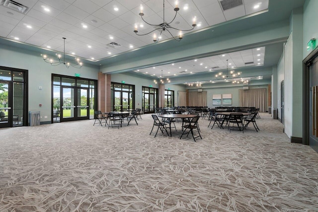 dining space with french doors and a high ceiling