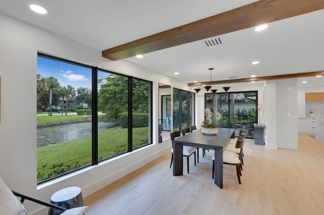 interior space with beamed ceiling and a water view