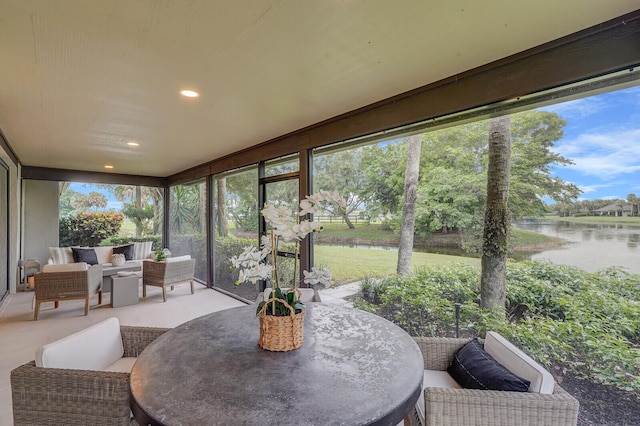 sunroom with a water view and a wealth of natural light