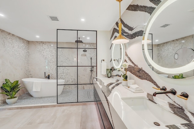 bathroom featuring vanity, separate shower and tub, and tile patterned floors