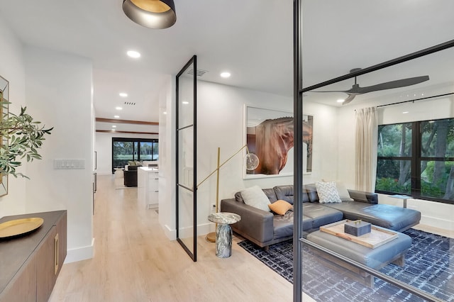 living room with light wood-type flooring and ceiling fan