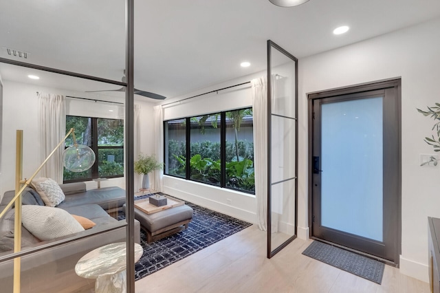 living room featuring light wood-type flooring and a water view