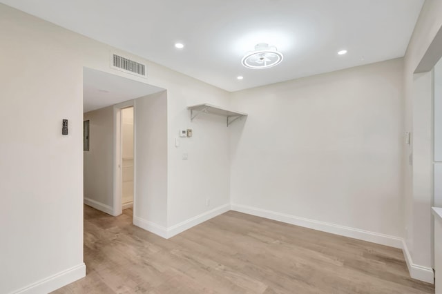 unfurnished room with light wood-type flooring