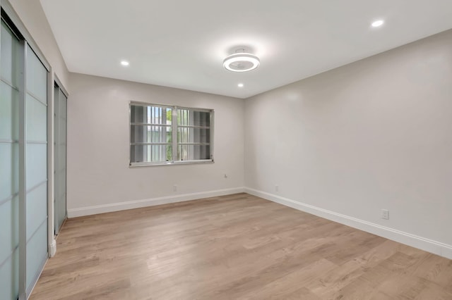 unfurnished bedroom with a closet and light hardwood / wood-style flooring