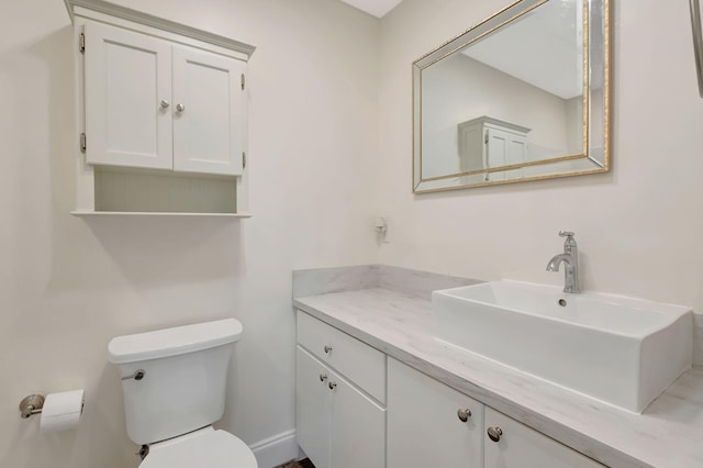 bathroom with toilet and vanity