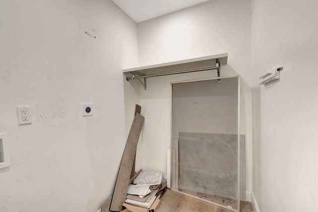 washroom with electric dryer hookup and wood-type flooring