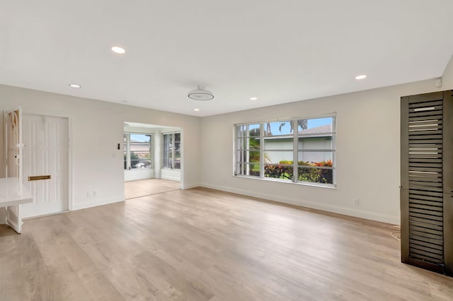 unfurnished living room featuring light hardwood / wood-style flooring and plenty of natural light