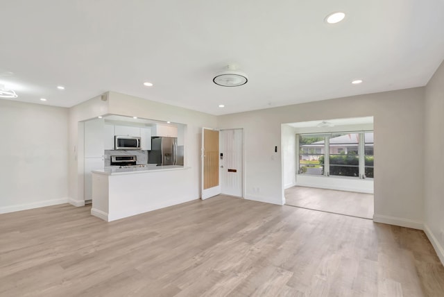 unfurnished living room featuring light wood-type flooring