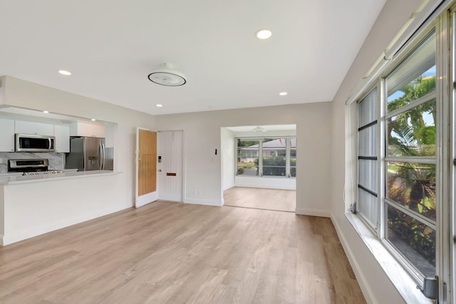 unfurnished living room with light wood-type flooring