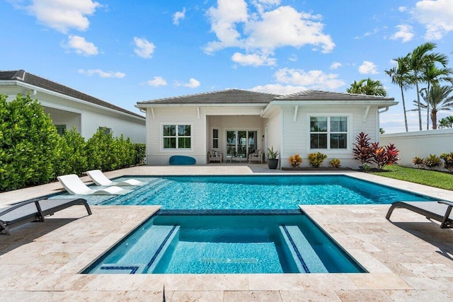 view of swimming pool featuring an in ground hot tub and a patio area