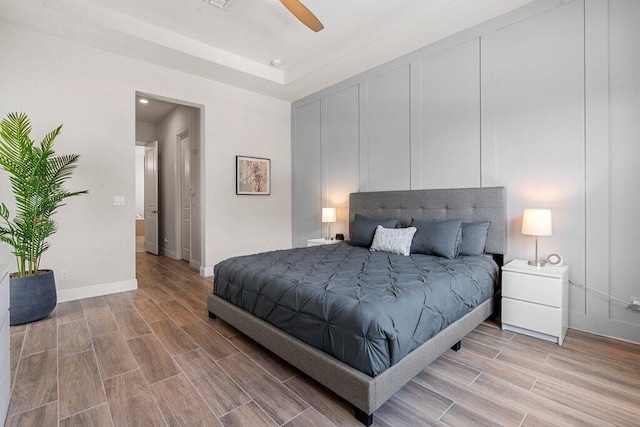 bedroom with light hardwood / wood-style flooring and ceiling fan