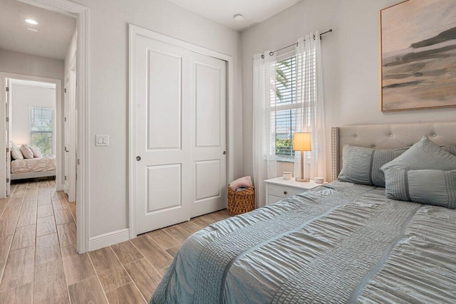 bedroom with light wood-type flooring and a closet