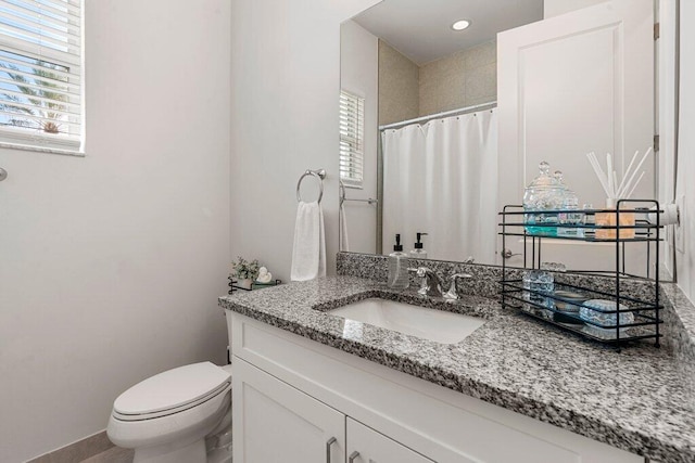 bathroom with a shower with curtain, toilet, and vanity