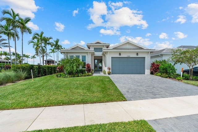 view of front of property with a garage and a front lawn