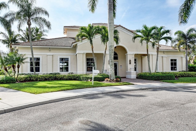 mediterranean / spanish house with a front yard