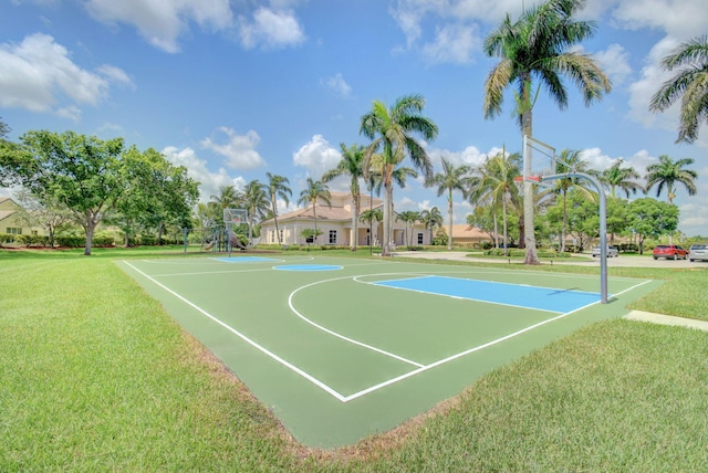 view of basketball court with a yard