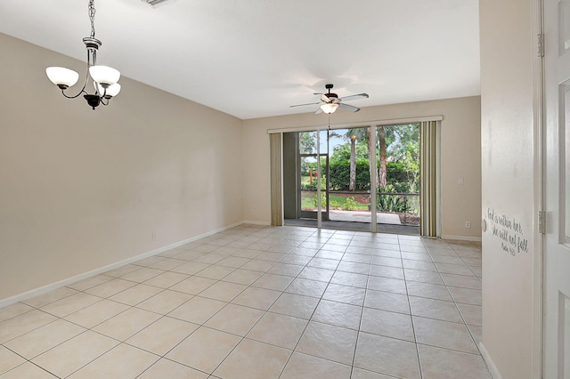 unfurnished room with ceiling fan with notable chandelier and light tile patterned floors