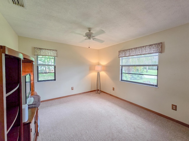 interior space featuring ceiling fan and a textured ceiling