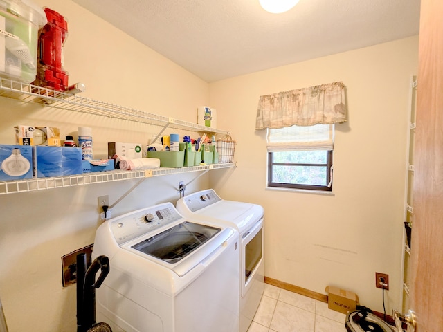 washroom featuring washer and dryer and light tile patterned flooring