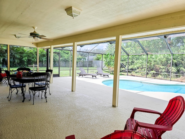 view of swimming pool featuring a lanai, ceiling fan, and a patio