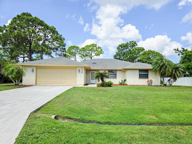 ranch-style house with a front yard and a garage