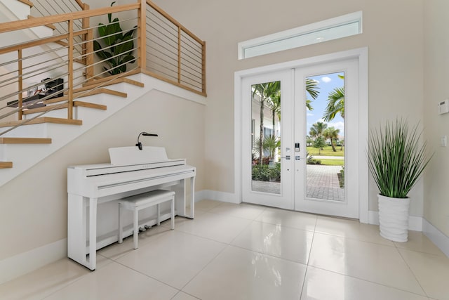 doorway with light tile patterned floors and french doors