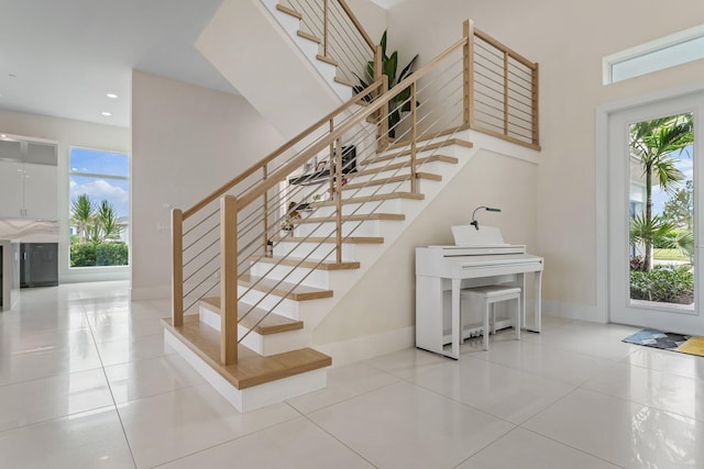 stairs with tile patterned flooring and plenty of natural light