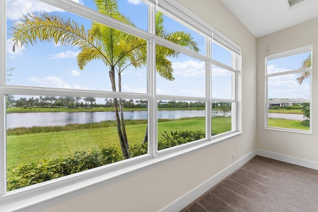 unfurnished sunroom featuring a water view