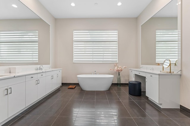 bathroom featuring vanity, a tub, and tile patterned flooring