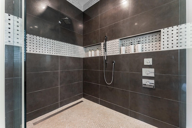 bathroom with tiled shower