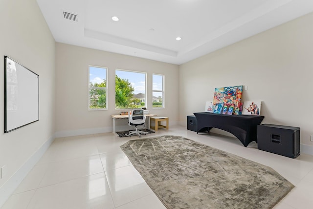 sitting room with light tile patterned floors and a tray ceiling