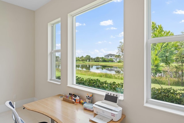 dining area featuring plenty of natural light and a water view