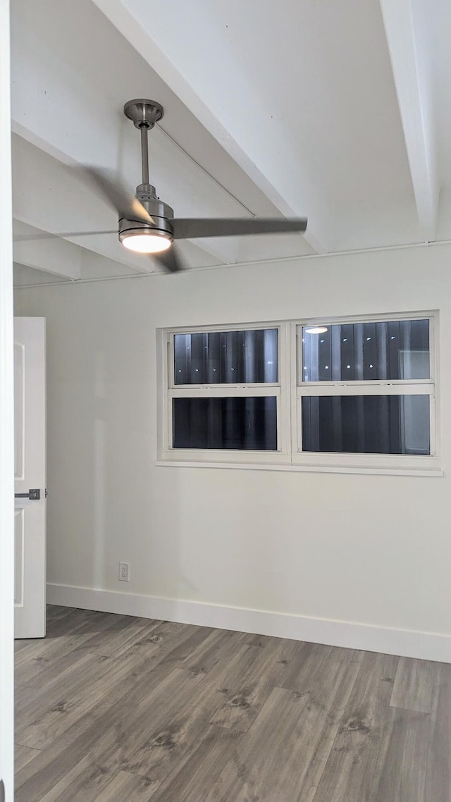 empty room featuring ceiling fan, beam ceiling, and hardwood / wood-style floors