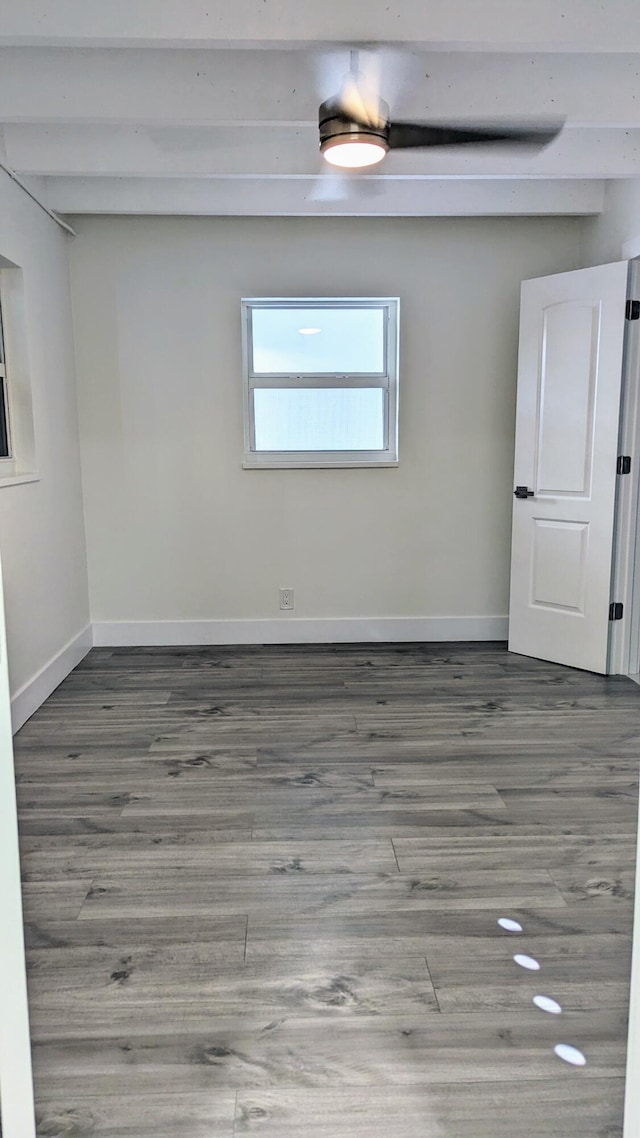 unfurnished room with hardwood / wood-style flooring and beam ceiling