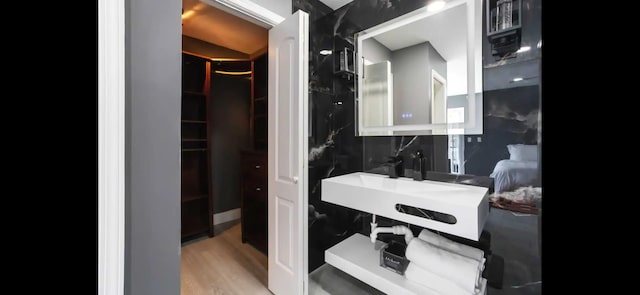 6785 Escondida Dr, Lake Clarke Shores, FL 33406 - bathroom featuring wood finished floors and a sink