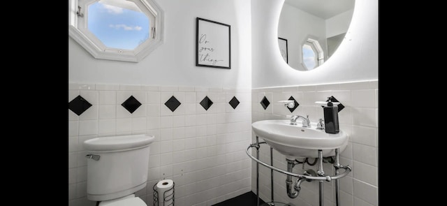 6785 Escondida Dr, Lake Clarke Shores, FL 33406 - half bath with toilet, tile walls, wainscoting, and a sink